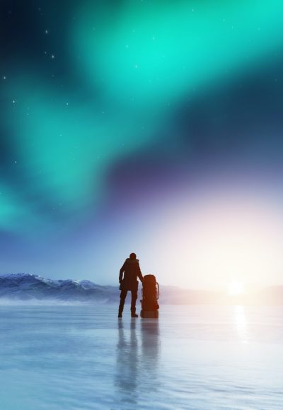 adventurous-man-standing-with-a-backpack-looking-at-aurora-.jpg